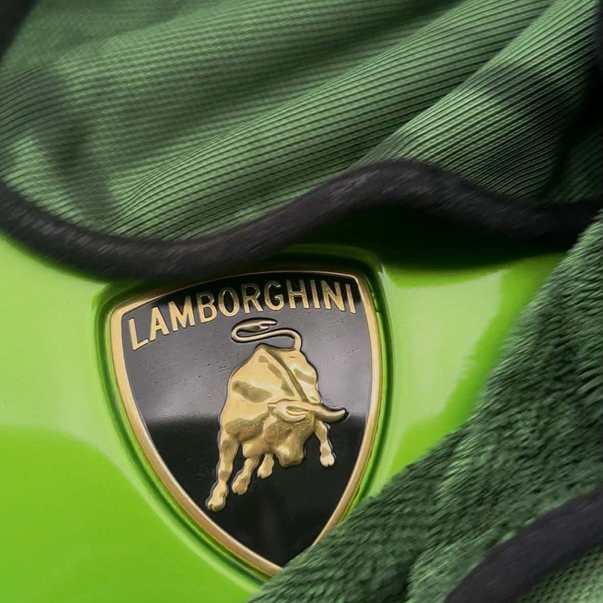 Mikrofiberdukar över Lamborghini-emblemet på en grön bil efter rekond av Senna Motors